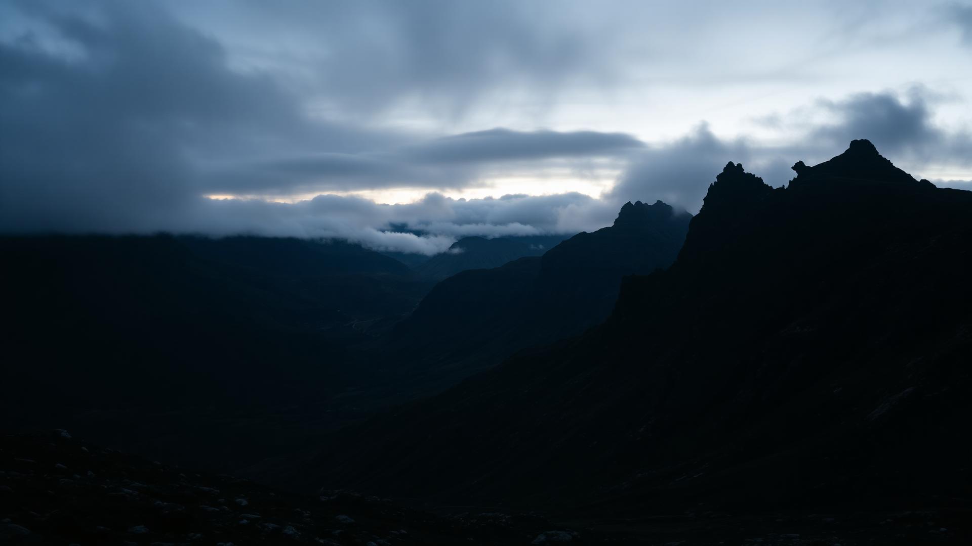 Welsh mountain silhouettes at dusk under storm clouds